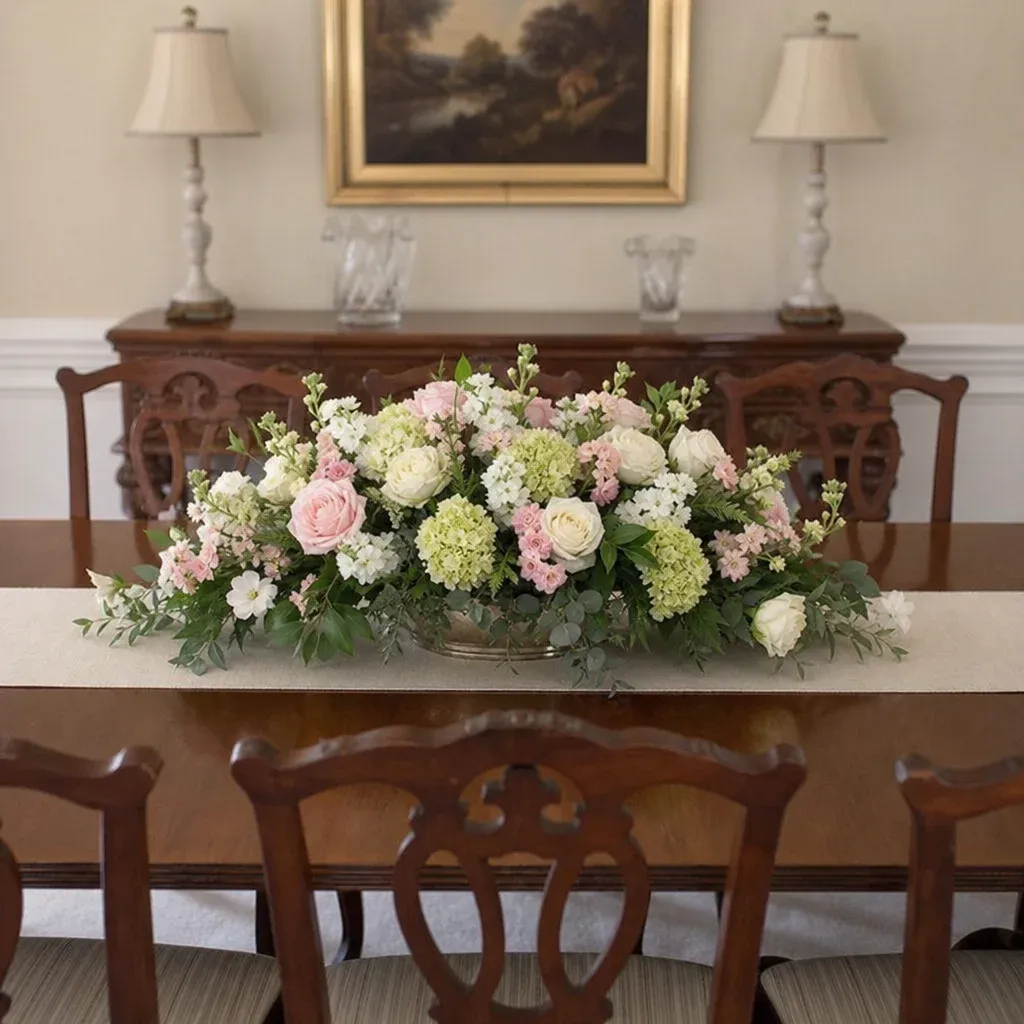 A perfectly proportioned floral centerpiece on a large dining table in English
